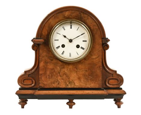 A 19th century burr walnut mantel clock, having a domed and shaped case containing a circular enamelled dial with Roman numer