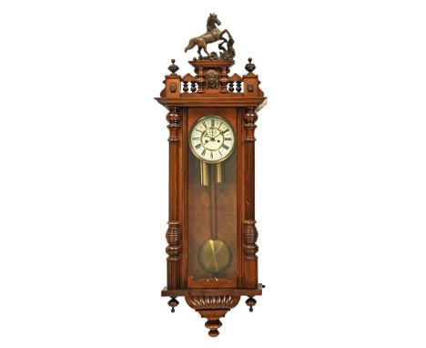 A late 19th century Viennese walnut wall clock, with eight day movement, white enamel dial with Roman numerals, glazed centra