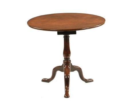 An early 19th century mahogany circular tilt top bird cage occasional table, with column support and tripod base terminating 