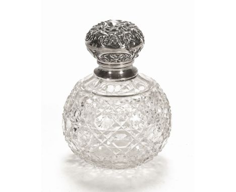 An Edwardian silver topped perfume bottle of sphere form, London 1912, makers mark rubbed.  13.5 cm high.