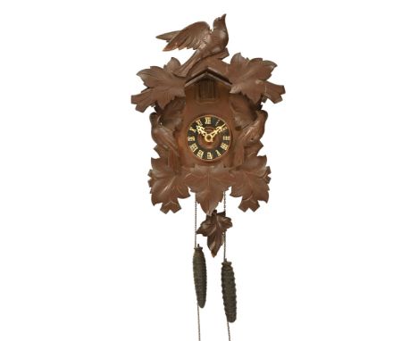 A 20th century stained frame Black Forest cuckoo wall clock, with bird and applique decoration, movement stamped Regular Germ