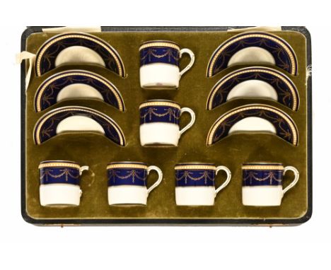 A Royal Worcester coffee set, consisting of six coffee cans and six plates with dark blue and gilt neoclassical design contai