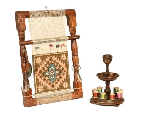 A stained wood tapestry loom, with turned supports.  55 cm long, together with an early 20th century circular and turned need