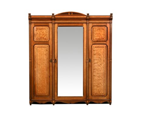 A Victorian mahogany and Tunbridge ware inlaid triple wardrobe, with carved cornice and parquetry decoration, having a centra