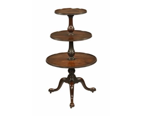 A George III mahogany whatnot, with three circular shelves interspersed with turned vase shaped supports raised on a tripod b