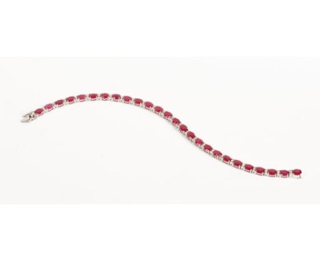 An 18 ct gold ruby and diamond bracelet, ruby weight +/- 11.95 carats, diamonds +/- .46 carats.  (see illustration).