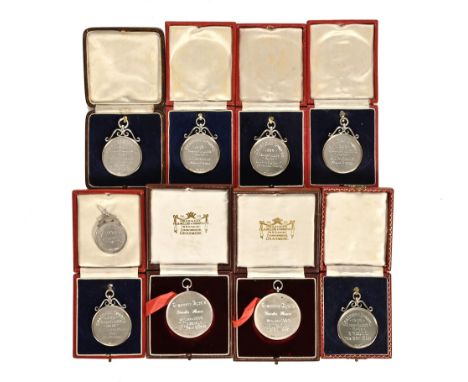 A collection of nine silver running medals awarded to W Teasdale, eight of which are boxed and all titled Grasmere Sports dat