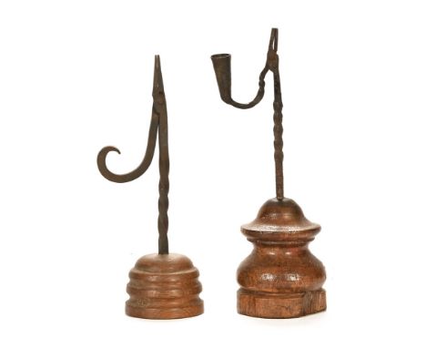 Two reed light holders, first possibly late 18th century with twisted shaft and turned carved base, height 35.5 cm, base diam