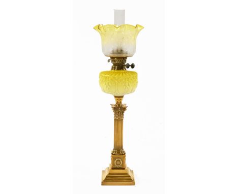 A Victorian Corinthian column brass and yellow glass oil lamp, double wick with flared floral etched shade.  Height 69 cm to 