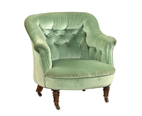 An Edwardian upholstered button back small armchair, with light green velvet fabric and turned front feet on castors.  74 cm 
