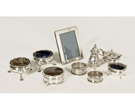 A pair of George III circular silver condiments, each raised on hoof feet, London 1770, maker D & R Hennell, each with blue g