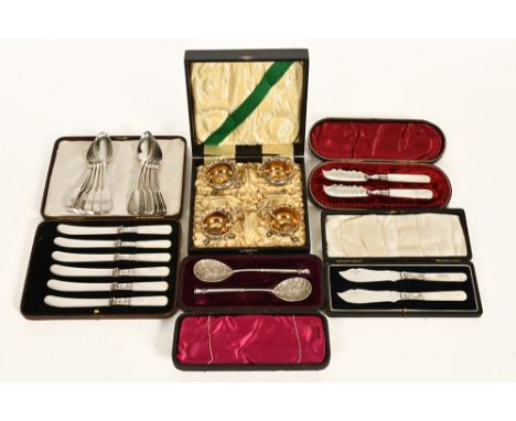 A pair of silver foliate engraved butter knives, Birmingham 1891, cased with twelve electroplated teaspoons and a cased pair 