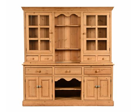 A reclaimed pine dresser, with an open section to centre and two shelves flanked on either side by cupboard doors and six gla