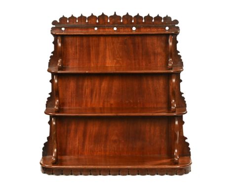 A 19th century mahogany wall shelf, with four graduating shelves scrolled supports and carved apron.  87 cm high, 82 cm wide.