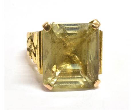 PRINCESS CUT CITRINE COCKTAIL RING The single stone measuring approx. 1.5 x 1.4cm, prong set on a textured yellow metal band.