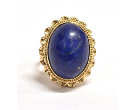 STAMPED 14K STATEMENT RING The ring set with an oval blue paste stone (Azure shade) measuring 1.6 x 1.1cm approx raised above