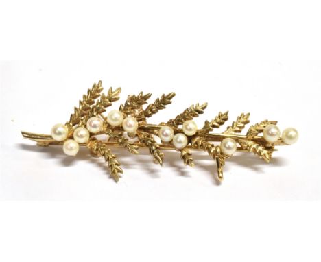 A 9CT GOLD SEED PEARL BAR BROOCH The brooch with textured leaf details, safety barrel catch and safety chain, length 5.1cm, w