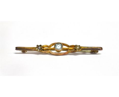 STAMPED 9C AQUAMARINE AND SEED PEARL BAR BROOCH The faceted round cut aquamarine measuring approx 4mm, centrally set in an op