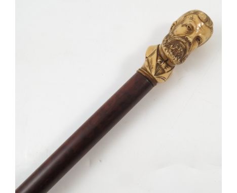 A Victorian walking stick, the ivory top carved with a bust of a bearded man, with hardwood shaft, length 36ins