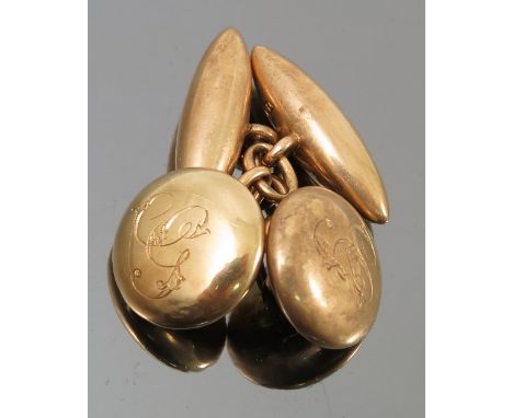 A pair of cufflinks, circa 1900, stamped '15' and 'R.F'?, the button shaped monogrammed panel chain linked to a torpedo shape