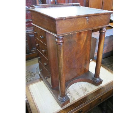 A 19th century mahogany Davenport, with rising lid, fitted four dummy drawers and four drawers, width 20ins