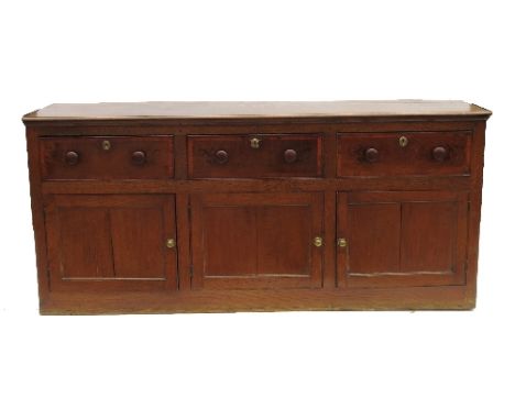 A 19th century oak cupboard dresser, having three cross banded drawers over three cupboard doors, width 76ins 