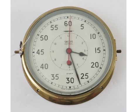 A Smiths Astral ship`s bulk head wall clock, no. AP160174, with white dial, winding hole and slow fast function, within a bra