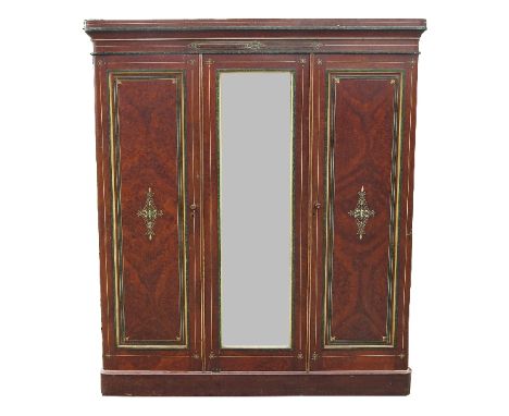 A 19th century faux amboyna wardrobe, having two painted doors and mirror door opening to reveal hanging space, drawers and s