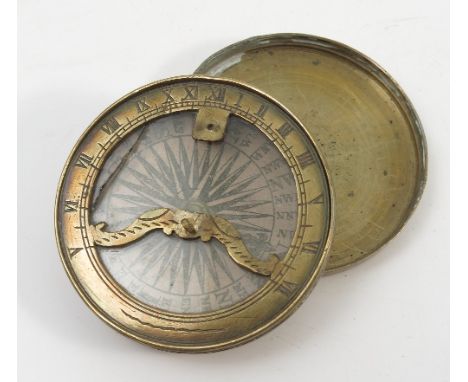 An Antique brass cased pocket compass, with paper dial, and engraving to the case, diameter 2.25ins