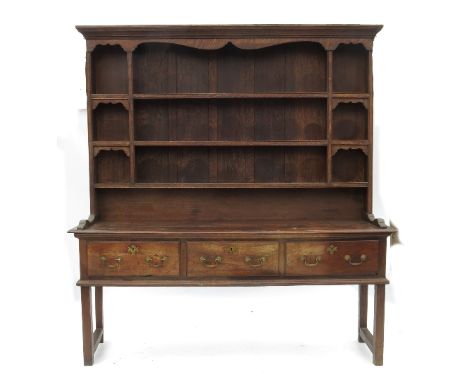 An Antique oak dresser, with close boarded Delft rack over, fitted three frieze drawers, raised on square legs, width 76ins 