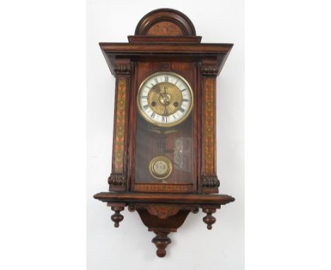 A Vienna style wall clock, with gilt and enamelled dial, the case with stained flower decoration, overall height 24ins 