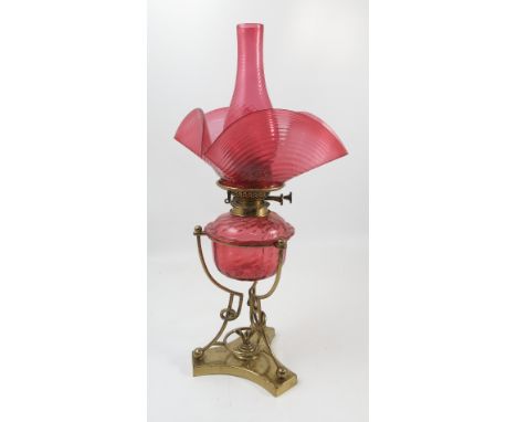A W H Honey oil lamp, having a cranberry glass chimney, cranberry shaped glass shade and cranberry glass oil reserve, all wit
