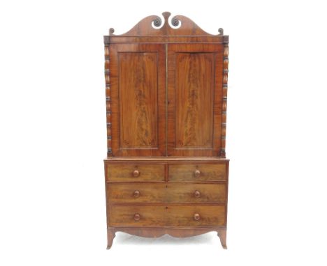 A late 19th century Georgian mahogany linen press, with two panelled doors having ebonised line inlay below a swan neck friez