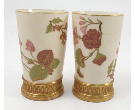 A pair of Royal Worcester ivory vases, of cylindrical form, decorated with flowers to a gilt foot rim, dated 1887, height 5in