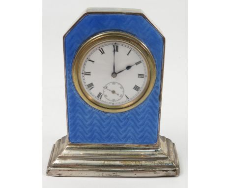 A silver mounted and enamel travelling clock, with rectangular case, having canted corners and stepped foot, with blue enamel