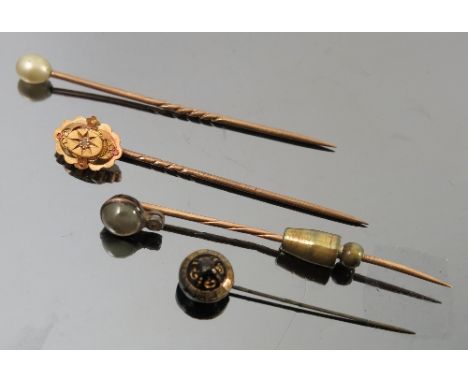 A chrysoberyl cats eye and diamond stick pin, cased, together with a Victorian rose diamond stick pin, cased and two other pi