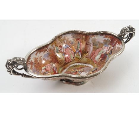 A 19th century Continental painted enamel quatrefoil shaped dish, decorated inside and out and the base with figures in lands