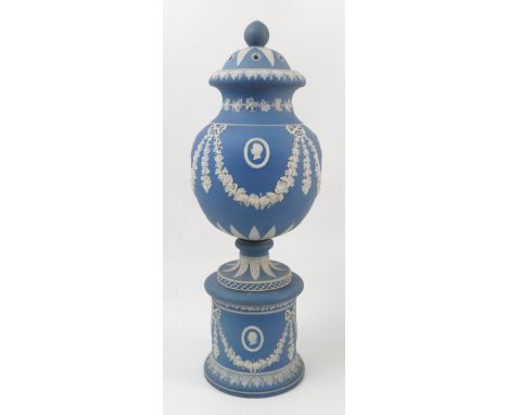 A 19th century jasper ware covered vase, with pierced lid, the body decorated with garlands of grapevine with portrait medall