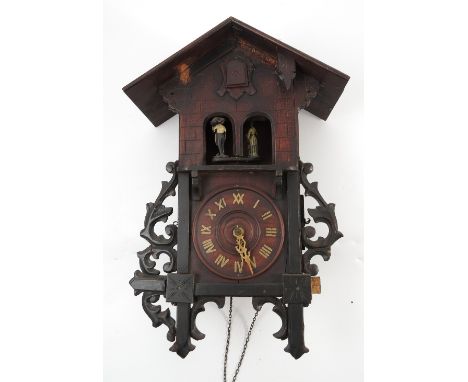 A Black Forest carved wooden cuckoo clock, of chalet style, with striking movement, two figures, cuckoo with bellows, the cas