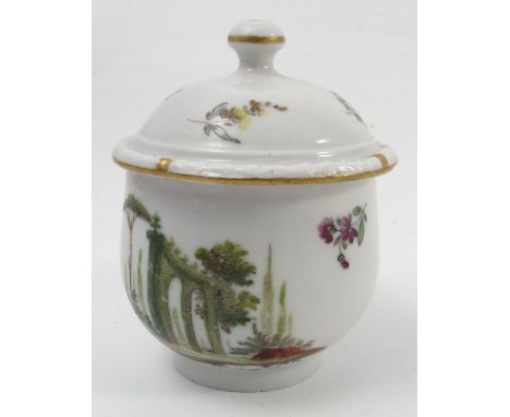 An 18th century Cozzi porcelain covered cup, decorated with a stone arch in landscape, with floral sprays, red anchor mark to