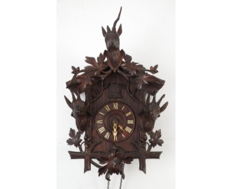 An F I Wehrle black forest cuckoo clock, striking movement stamped 1109, with bellows, the case decorated with deer and goats
