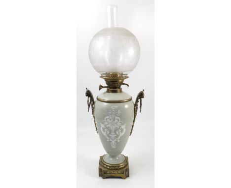 A table lamp, formed as green glazed vase, with pate sur pate decoration, and gilt metal mounts, height 26ins 