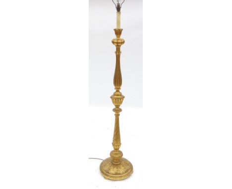 A gilt standard lamp, with turned and fluted column, terminating in a leaf moulded base