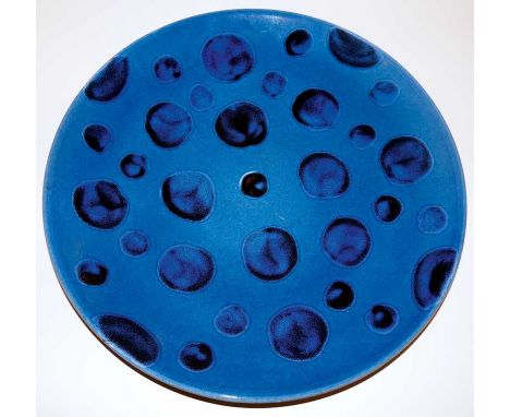 A Poole pottery charger decorated with blue spots on a blue ground, 39.5 cm diameter, moulded mark, modern