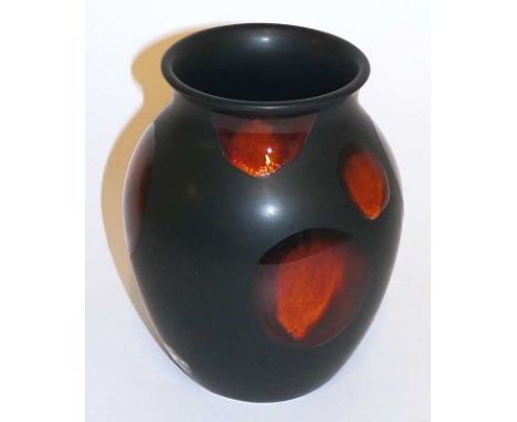 A Poole pottery "living glaze" vase the matt black body with red orange spots, 16.5 cm high, printed mark in black and bearin