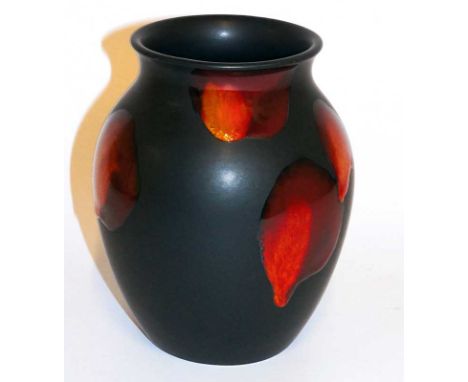 A Poole pottery "living glaze" vase the matt black body with red orange spots, 16.5 cm high, printed mark in black and bearin