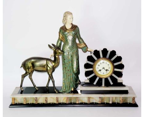 An Art Deco mantel clock the white onyx and black slate sunburst frame enclosing cream enamel dial with Arabic numerals flank