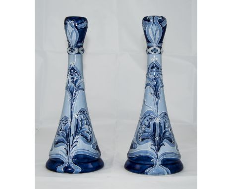 Moorcroft Macintyre Florian Ware Pair of Candlesticks, 'Iris' pattern, an Art Nouveau tubelined design in shades of blue, on 