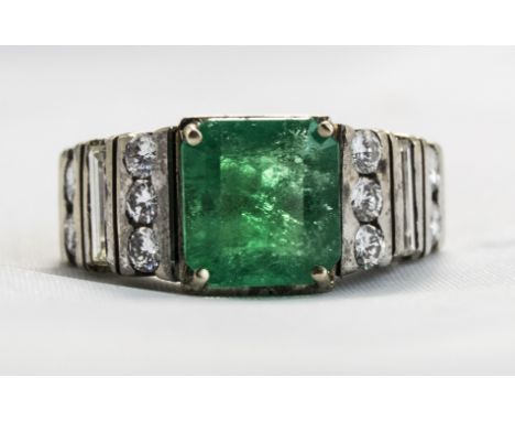 18ct White Gold Set Emerald And Diamond Ring. The Single Step Cut Emerald of Good Colour with Diamond Set Shoulders. Emerald 