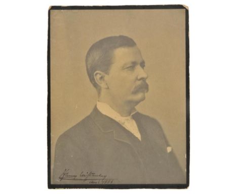 *Stanley (Sir Henry Morton, 1841-1904). A signed portrait photograph, 1886,  carbon print mounted on card, signed in ink 'Hen